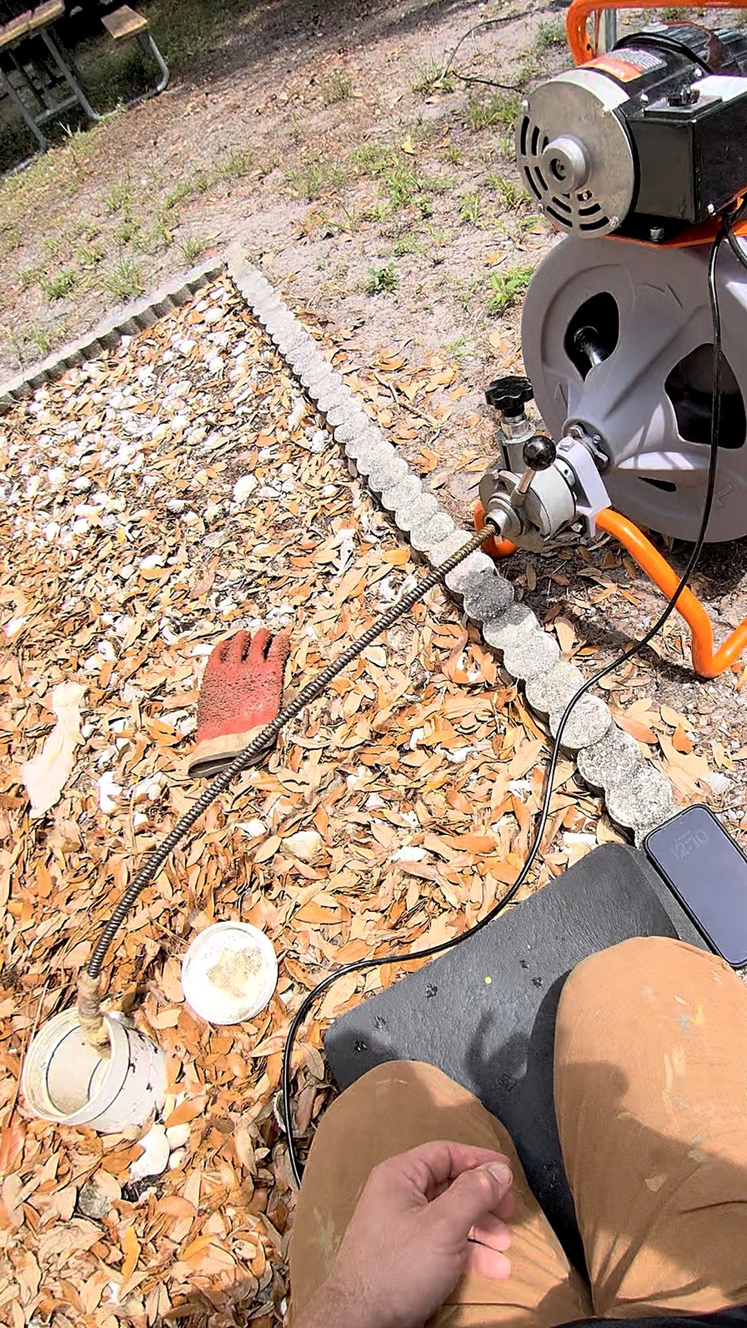 Drain clearing with an auger